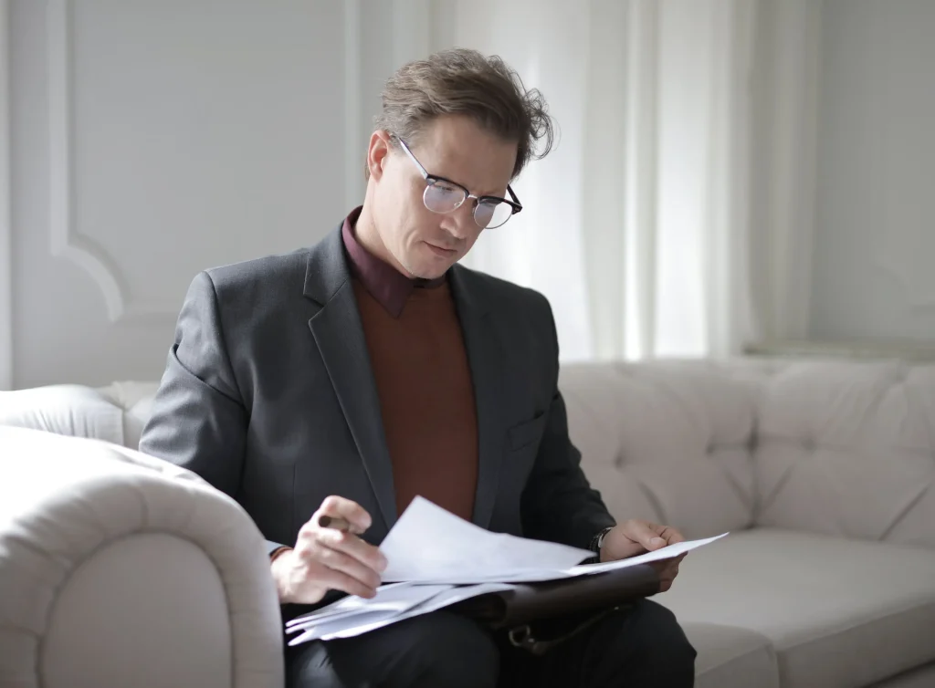 Business man reading tax notice.